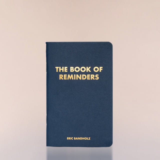 The Book of Reminders by Eric Bandholz against a neutral background.