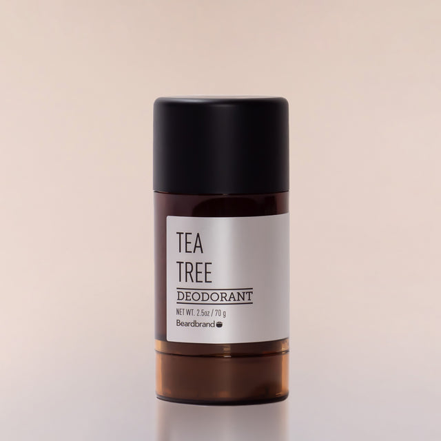 A round tube of Beardbrand Tea Tree Deodorant against a neutral background.