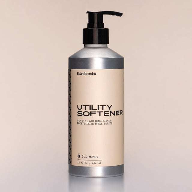 A bottle of Utility Softener with a pump dispenser against a neutral background.